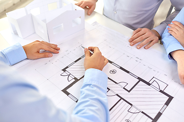 Image showing close up of architects with blueprint at office