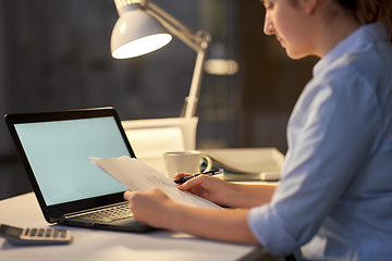 Image showing woman with laptop and papers at night office