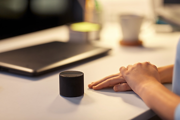 Image showing close up of hand with smart speaker at office