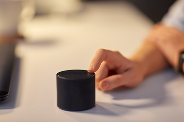 Image showing close up of hand with smart speaker at office