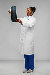 Image showing african american female doctor looking at x-ray