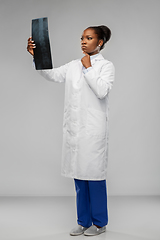 Image showing african american female doctor looking at x-ray