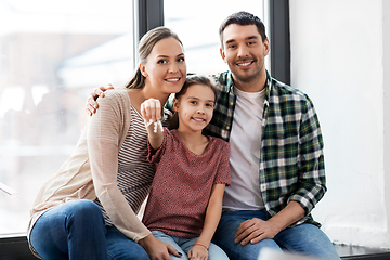 Image showing happy family with house keys moving to new home