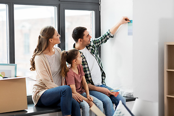 Image showing happy family with color palette moving to new home