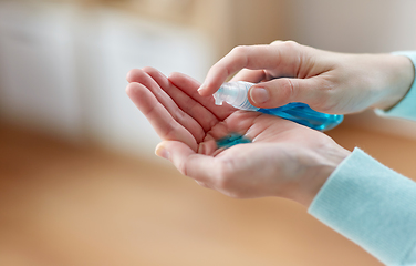 Image showing close up of woman spraying hand sanitizer