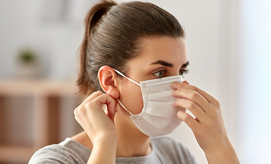 Image showing young woman wearing protective medical mask