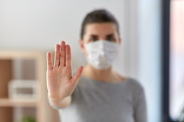 Image showing woman in protective medical mask making stop sign