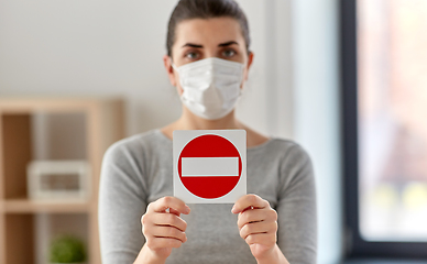 Image showing woman in protective medical mask showing stop sign