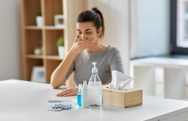 Image showing medicines and sick woman coughing at home
