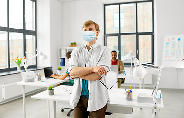 Image showing man with glasses in medical mask at office