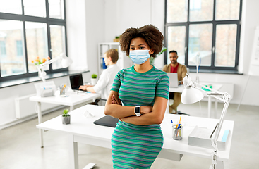 Image showing woman with smart watch in medical mask at office