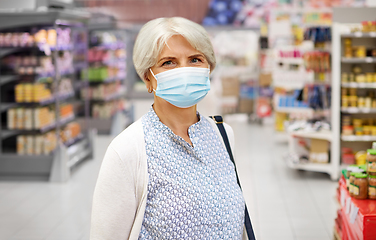 Image showing senior woman in medical mask at supermarket