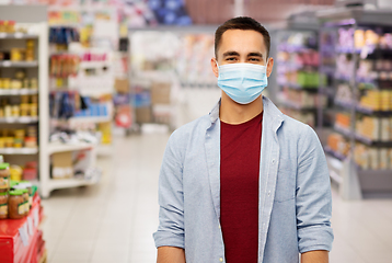 Image showing young man in medical mask at supermarket