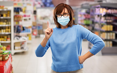 Image showing angry senior woman in medical mask at supermarket