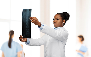 Image showing african american female doctor looking at x-ray