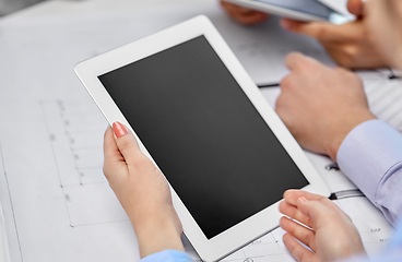 Image showing architects with tablet pc and blueprint at office