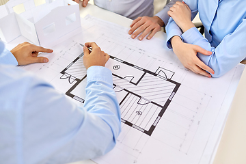 Image showing close up of architects with blueprint at office