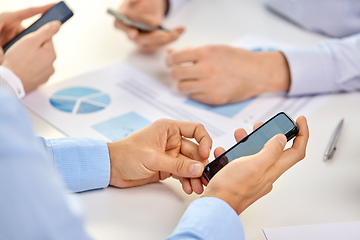 Image showing businesspeople with smartphones at office