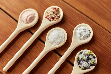 Image showing spoons with salt and spices on wooden table