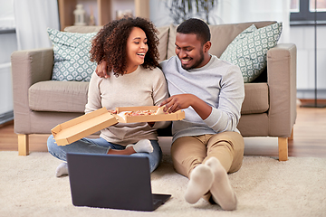 Image showing happy african american couple eating pizza at home