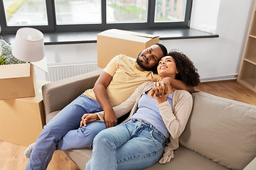 Image showing happy couple with boxes moving to new home