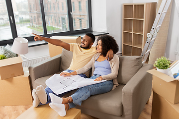 Image showing couple with boxes and blueprint moving to new home