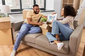 Image showing happy couple with boxes moving to new home