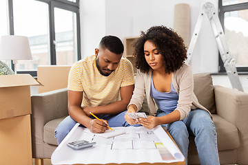 Image showing couple with blueprint counting money at home