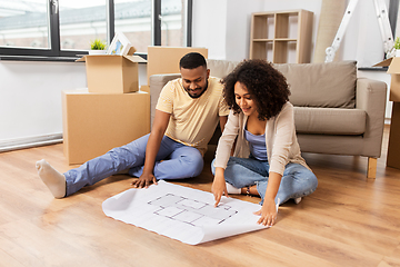 Image showing couple with boxes and blueprint moving to new home