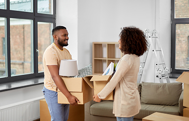 Image showing happy couple with boxes moving to new home