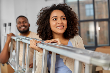 Image showing happy couple with ladder moving to new home