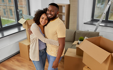 Image showing happy couple with boxes moving to new home