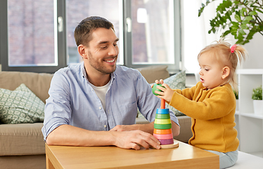 Image showing father playing with little baby daughter at home