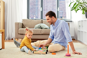 Image showing father playing with little baby daughter at home