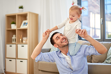 Image showing father riding little baby daughter on neck at home