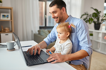 Image showing working father with baby daughter at home office