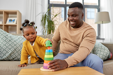 Image showing african family playing with baby daughter at home