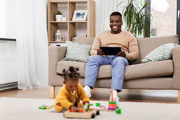 Image showing happy father with tablet pc and baby at home