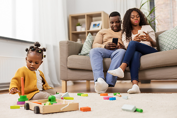 Image showing african baby girl playing with toy blocks at home