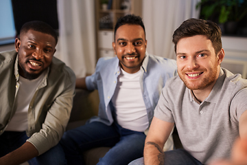 Image showing happy male friends taking selfie at home