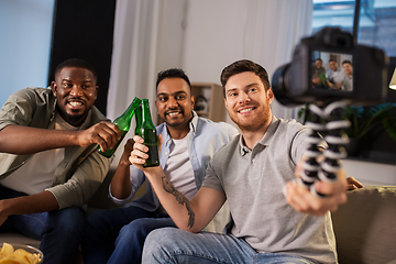 Image showing male video blogger with friends and camera at home