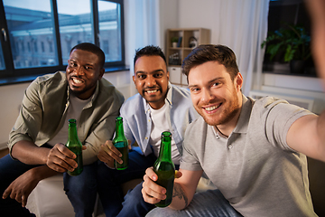 Image showing happy male friends with beer taking selfie at home