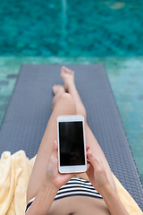 Image showing Woman use of mobile phone in swimming pool