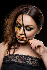 Image showing beautiful young woman with zipper on face