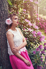 Image showing girl in dress in rhododendron garden