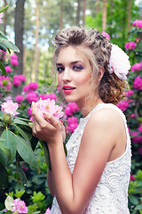 Image showing girl in dress in rhododendron garden