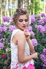 Image showing girl in dress in rhododendron garden