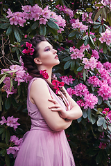 Image showing girl in dress in rhododendron garden