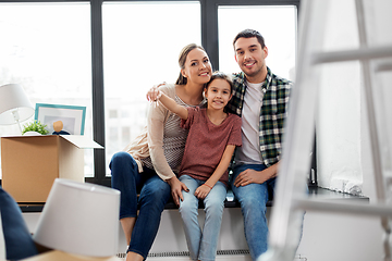 Image showing happy family with house keys moving to new home