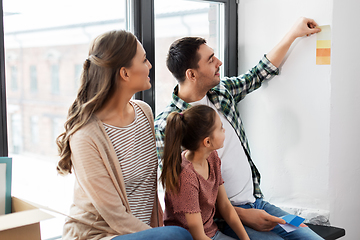 Image showing happy family with color palette moving to new home